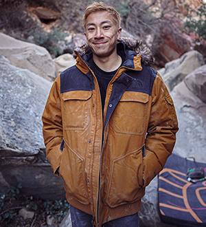 Tristan Chen standing outside in snow amongst boulders