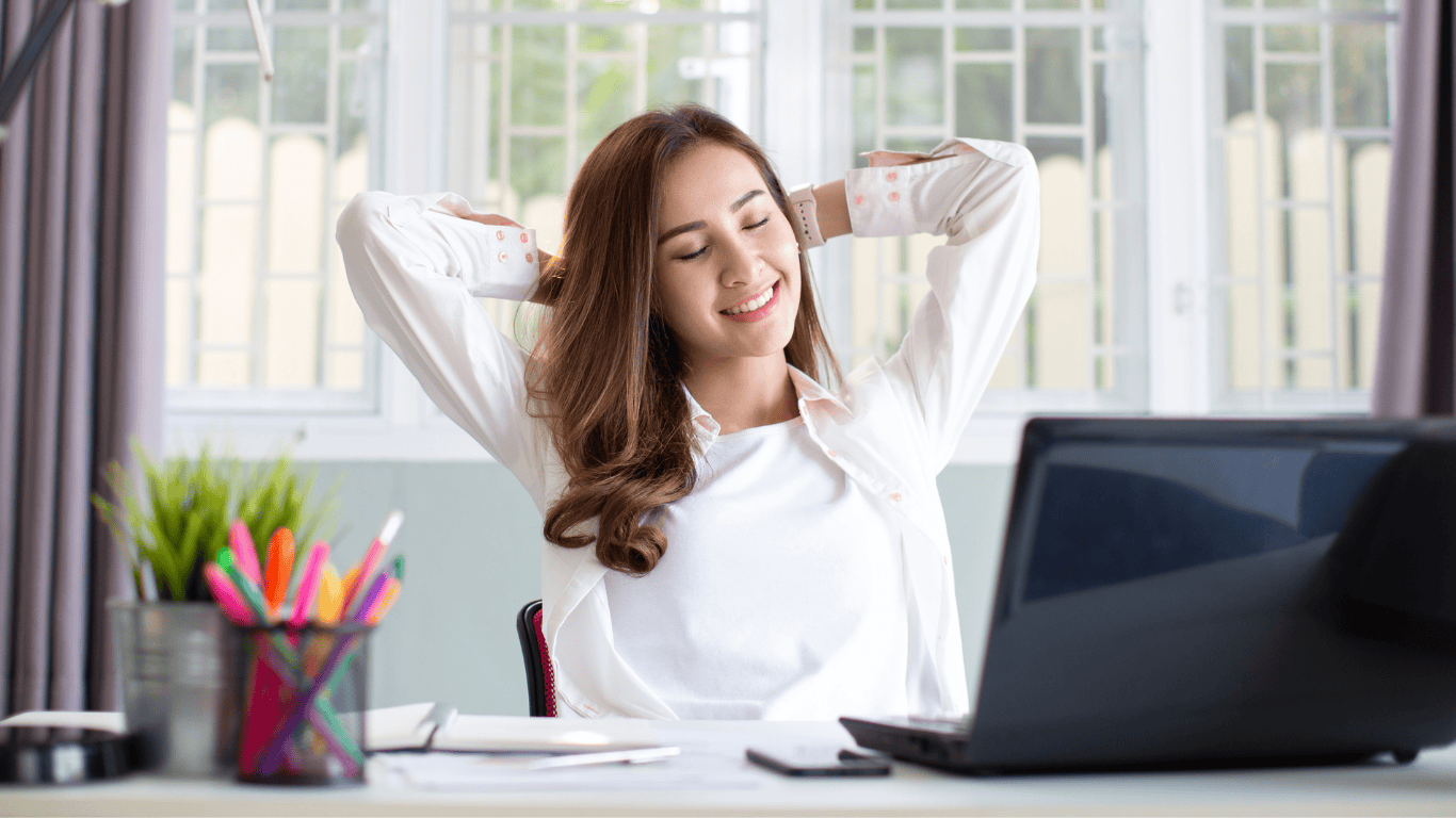 Woman looking confidently relaxed at her work desk