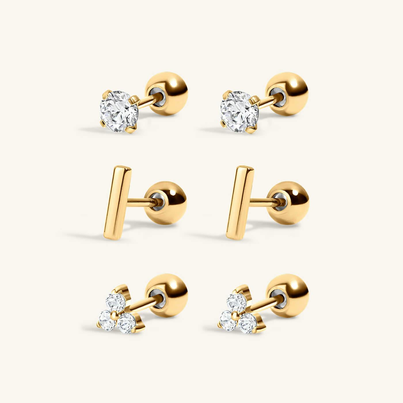 Everyday Earrings Trio in Titanium with Celestial Crystal Studs in Titanium, Little Bar Studs in Titanium, and Mini Crystal Trinity Studs in Titanium (gold)