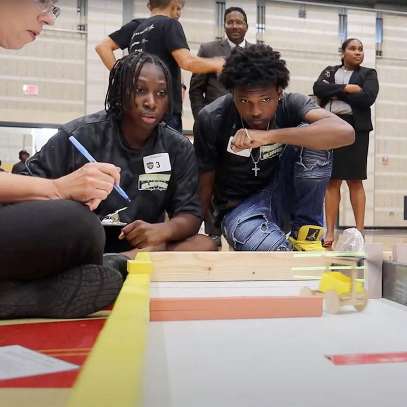 students build rubber band-powered carts