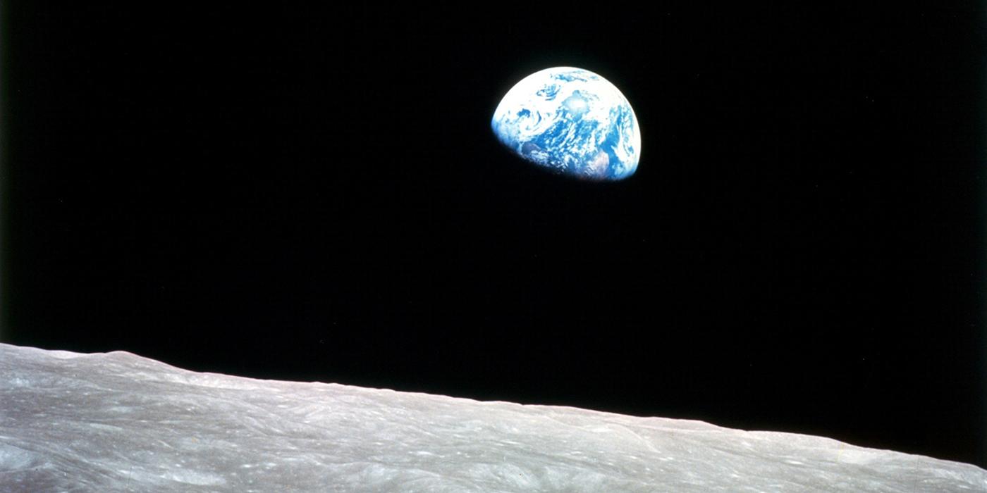 A picture of partially-shadowed Earth, as seen from the cold, gray surface of the Moon.