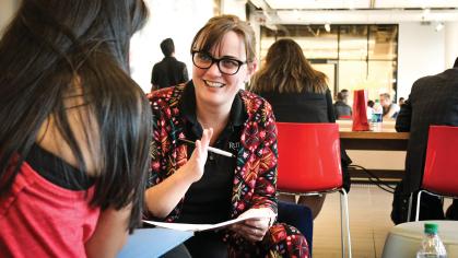 An advisor speaks with a student