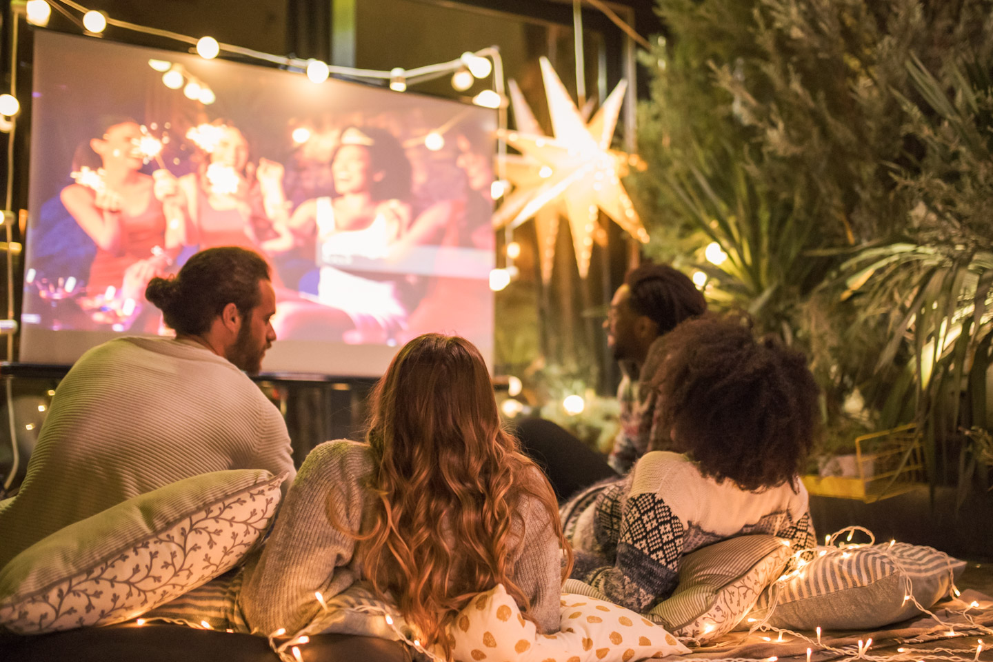 Friends watching a film in a projector