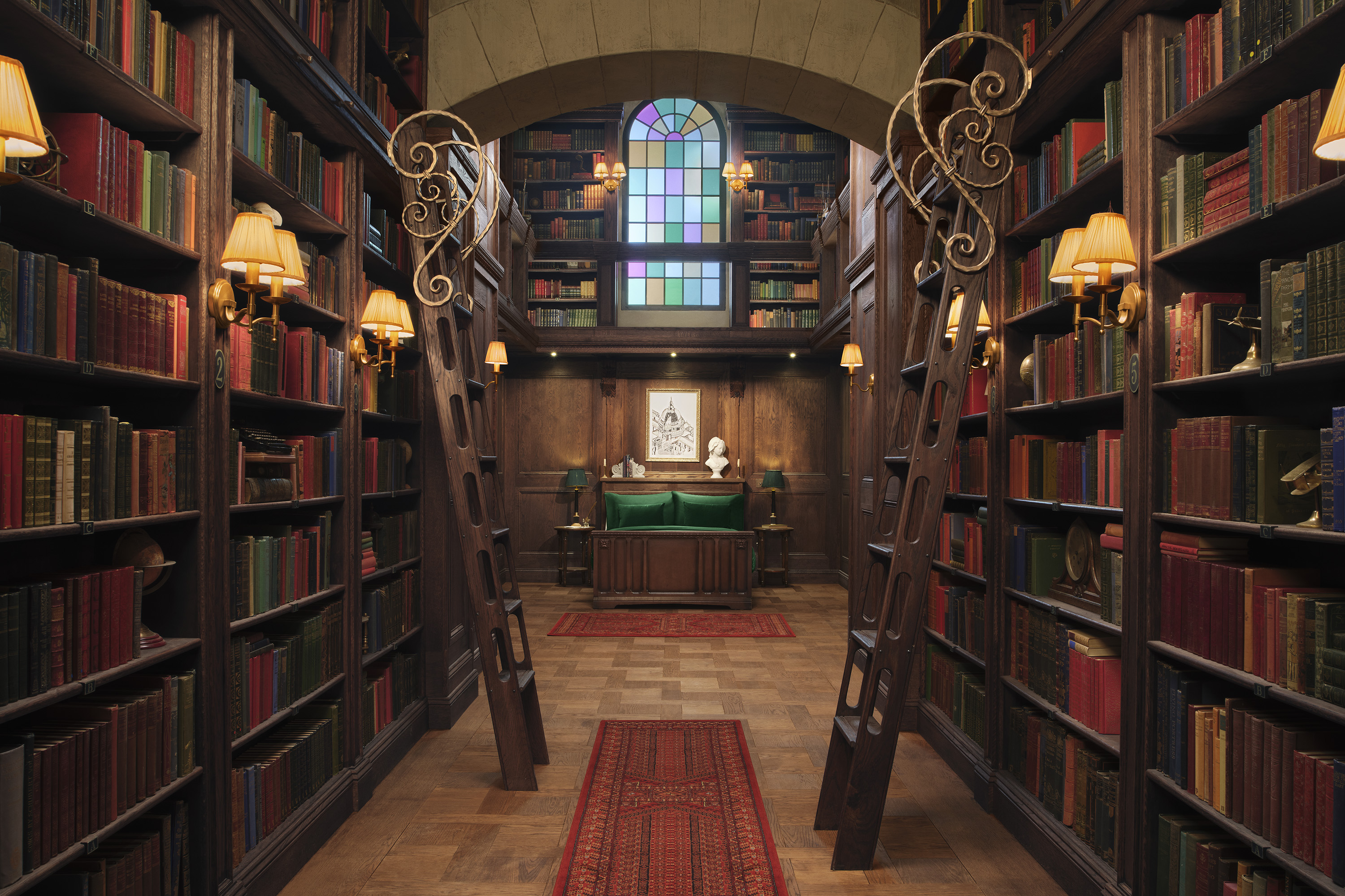 The bedroom section of the Hidden Library, a book lined and wood panelled room.