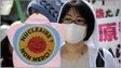 A protester holds a placard during a rally demanding the stop of the Hamaoka nuclear power plant in Tokyo on April 10, 2011