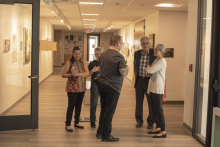 Faculty conversing in the art building.