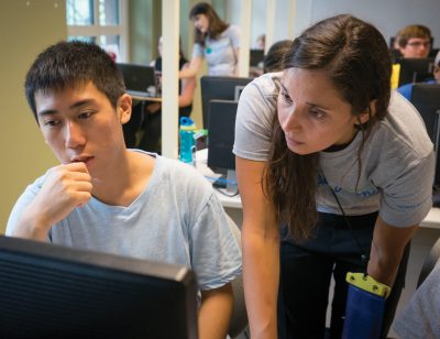 woman teacher helping male student