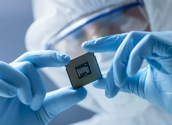 lab worker holds computer chip