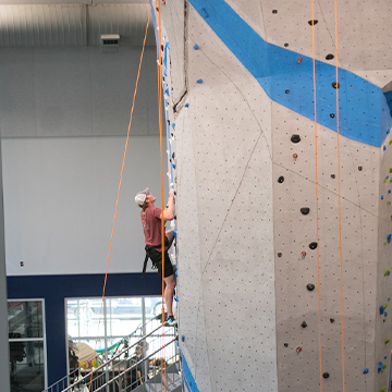 woman doing outdoor rock climbing