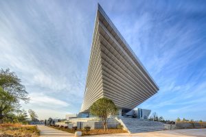 The Qujing Culture Center exterior featuring a unique architectural design with concrete and metal panels