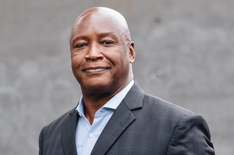 Portrait of a gentleman wearing a business suit, smiling.