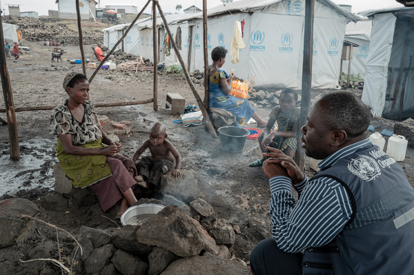 Dr Alain Mangolopa, WHO Emergency Officer for North Kivu, talks to Wemana, who fled her home and is currently sheltering at Bushagara Internally Displaced Persons (IDP) Camp, north of Goma in the Democratic Republic of the Congo (DRC), on 15 August 2024. The identification of mpox cases in IDP camps around Goma is concerning because the high population density can result in further spread, and population movements can hamper response efforts.  On 14 August 2024, WHO Director-General Dr Tedros Adhanom Ghebreyesus determined that the upsurge of mpox in DRC and a growing number of countries in Africa constitutes a public health emergency of international concern (PHEIC) under the International Health Regulations (2005) (IHR). Related: https://www.who.int/news/item/14-08-2024-who-director-general-declares-mpox-outbreak-a-public-health-emergency-of-international-concern