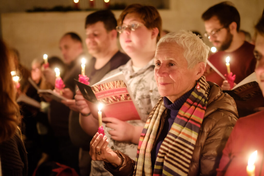 Lovefeast attendees singing with candlelight