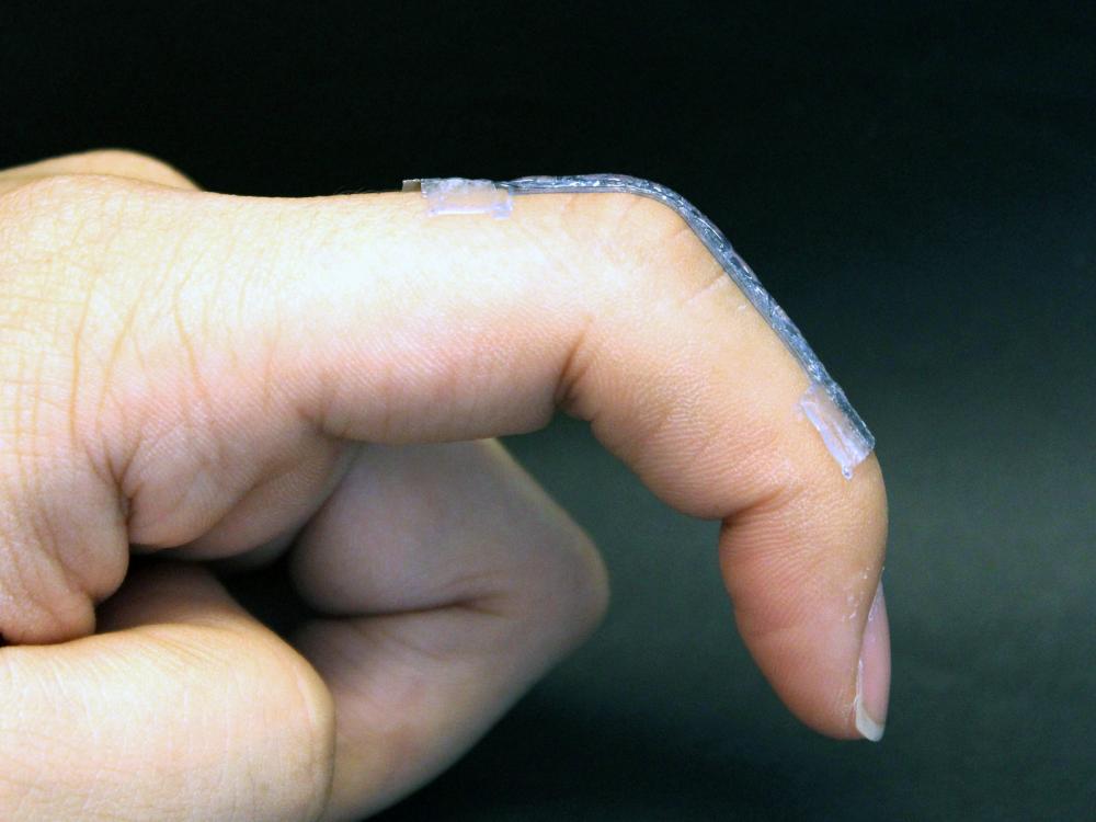 A sensor conforms to a finger as the finger bends. 