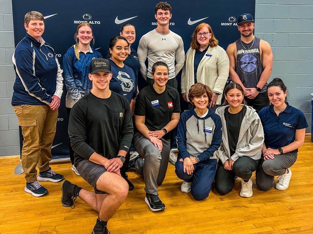 Group photo of faculty and students in front of Penn State Mont Alto athletics banner after the Functional Movement Screen.