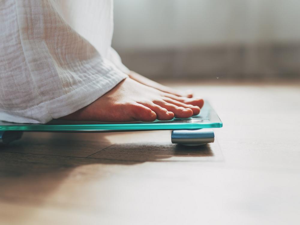 Feet standing on an electronic scale.