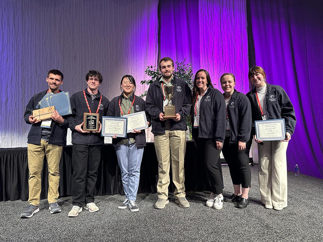 Group of people holding awards