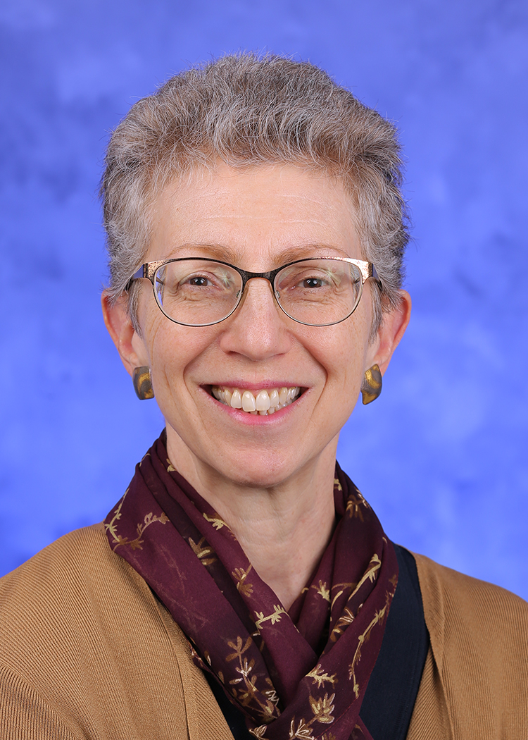 Bernice Hausman, PhD, is chair of the Department of Humanities at Penn State College of Medicine. She is pictured wearing a professional outfit and scarf.