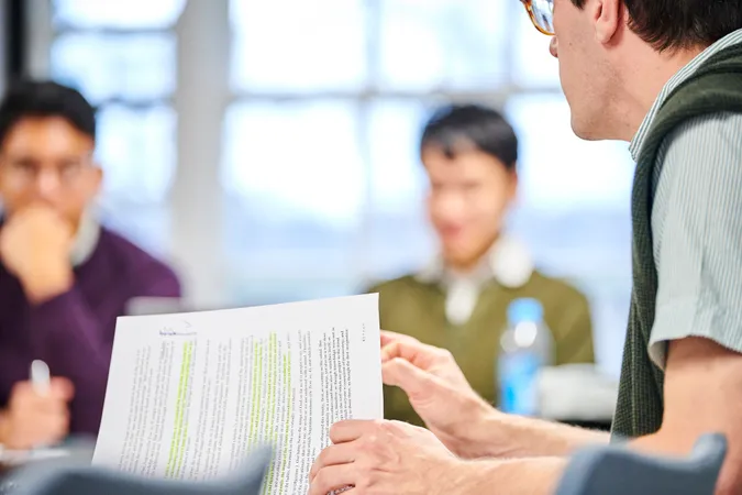 Professor working through notes in a class