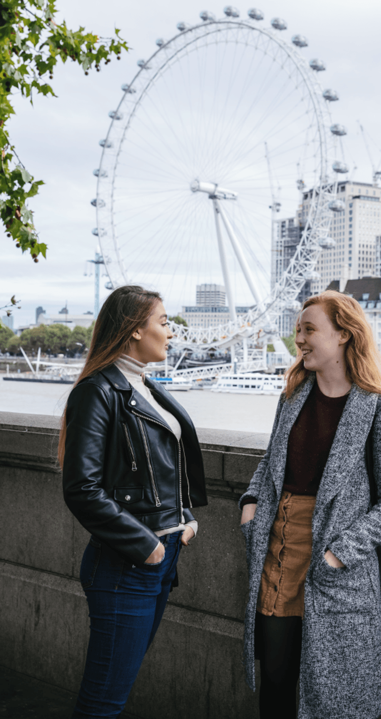 students by the river Thames, next to Westminster Bridge, London eye in the background