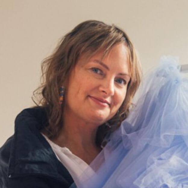 Business owner Elizabeth Dye with one of her gowns.