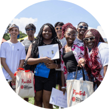 students on McKeldin Mall during Free Fest carrying tote bags