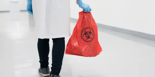 A hospital worker practicing good medical waste management