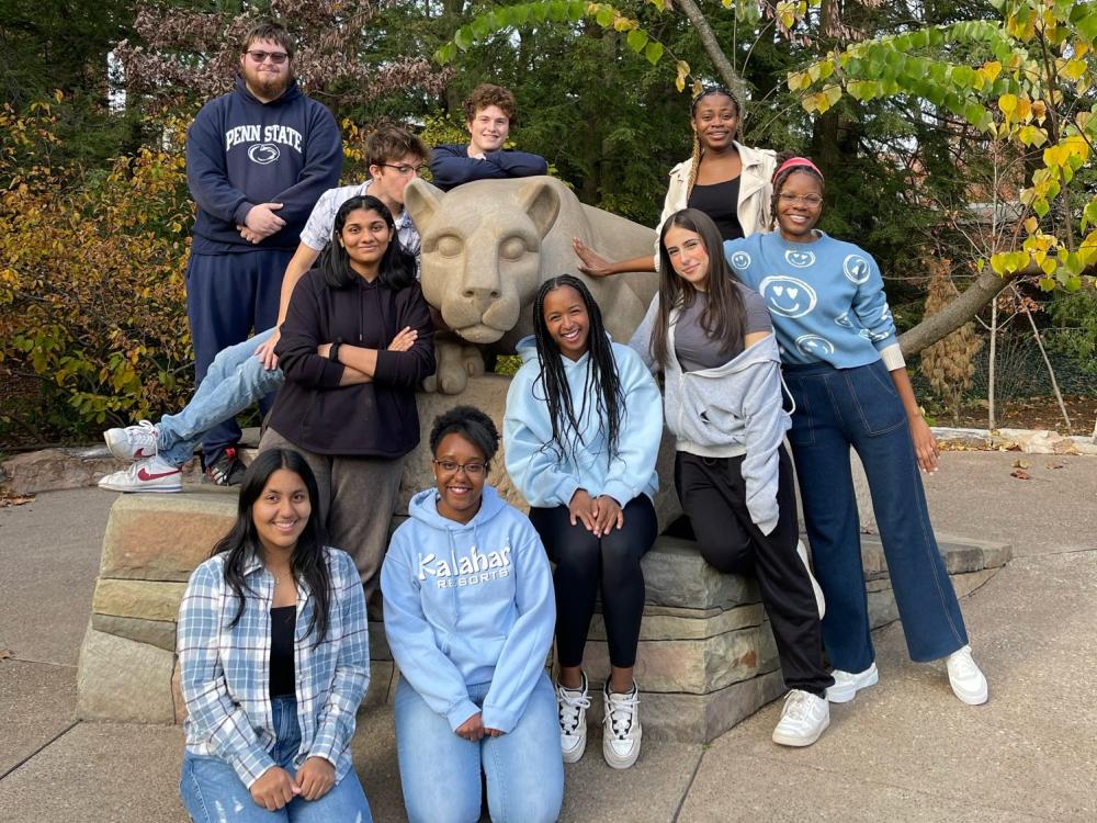 Ten students pose at Penn State's Nittany Lion shrine.