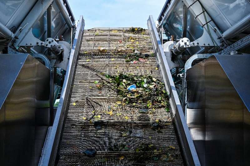 Trash collected by the Interceptor barge rolls up a conveyor belt before being dropped into dumpsters