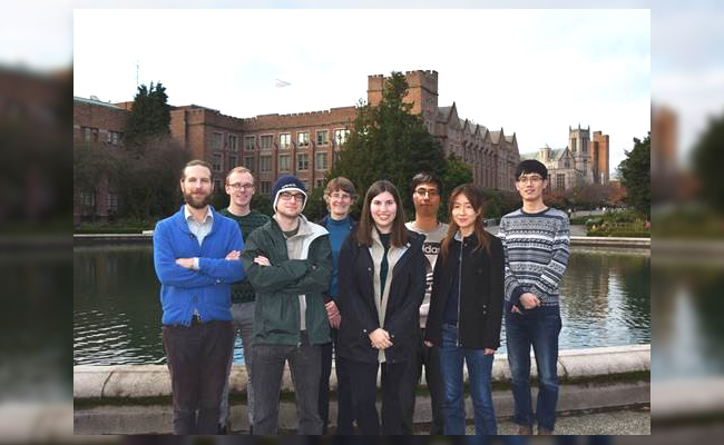 Team members standing on the UW campus