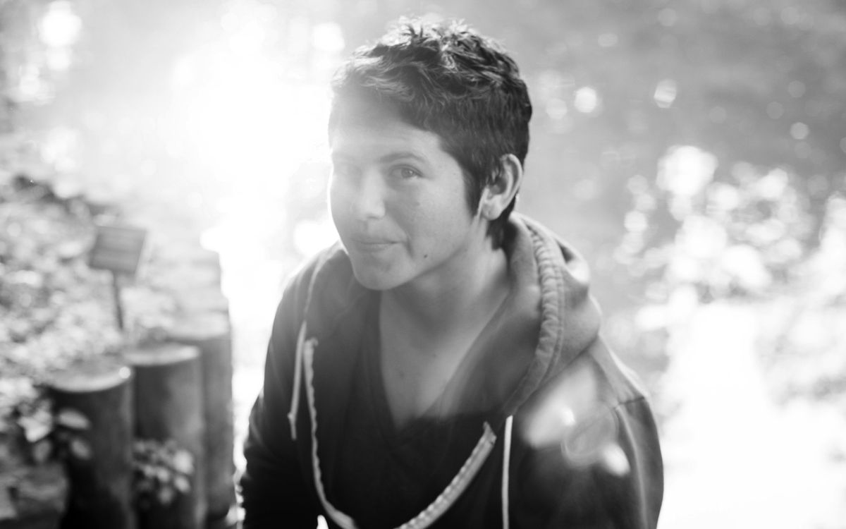 Black and white portrait photo of a woman with short cropped dark hair outdoors