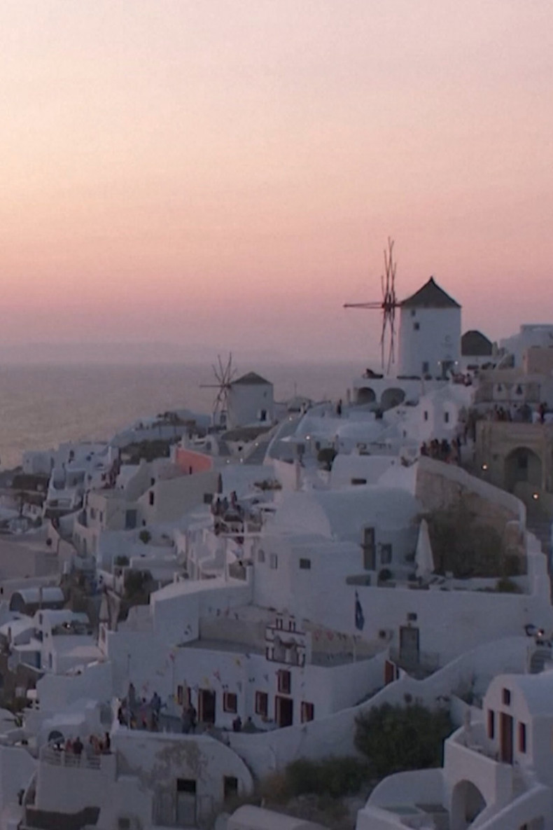 Greece's Santorini bursts with tourists as locals seek cap