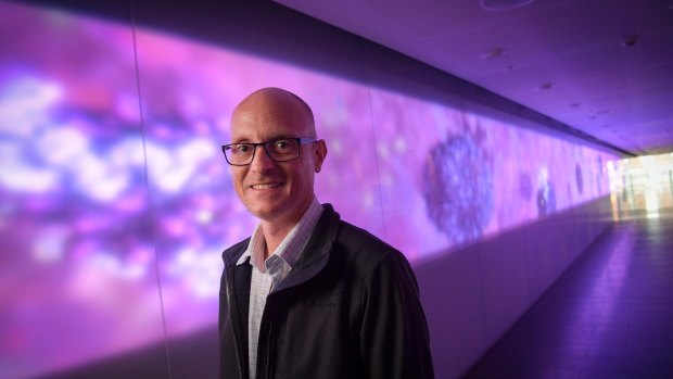 Biomedical animator Drew Berry at the Walter and Eliza Hall Institute's illuminated 27-metre artwork <i>Fiat Lux</i>.