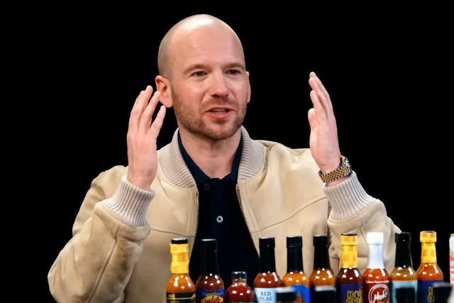 <p>Sean Evans and a lineup of hot sauces on ‘Hot Ones’ </p>