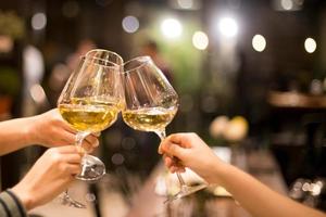 Friends toasting with glasses of wine photo