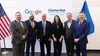 a group of people standing in front of a wall with signs that read "Google" and "Charter Oak"