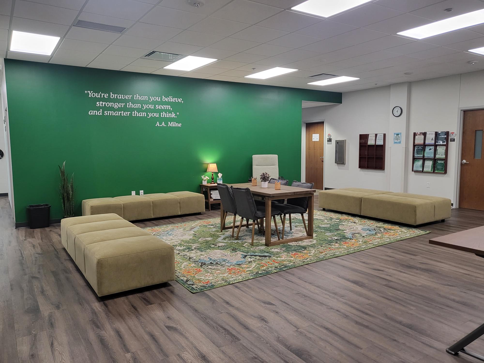 lobby of the center for counseling and testing department with green wall tables and couches