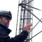 utility worker standing with augmented reality helmet on