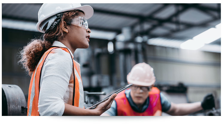 woman in hard hat holding a tablet