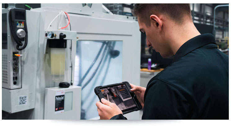 man looking at work instructions on a tablet