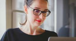 Woman with glasses at laptop