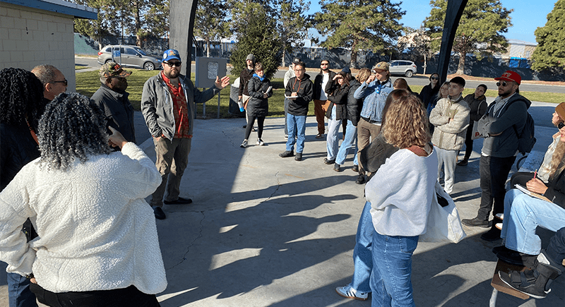 Professor Robert Franklin speaking to a group of students and community members outside.