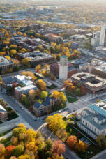 Burton Memorial Tower stands above an autumn scene on central campus.