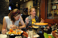 University Musical Society members share a laugh over dinner at the Pizza House where they were meeting with other UMS members.