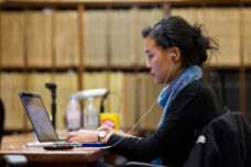 A student works on an article about the Ann Arbor City Council for the next day's issue of the Michigan Daily newspaper.