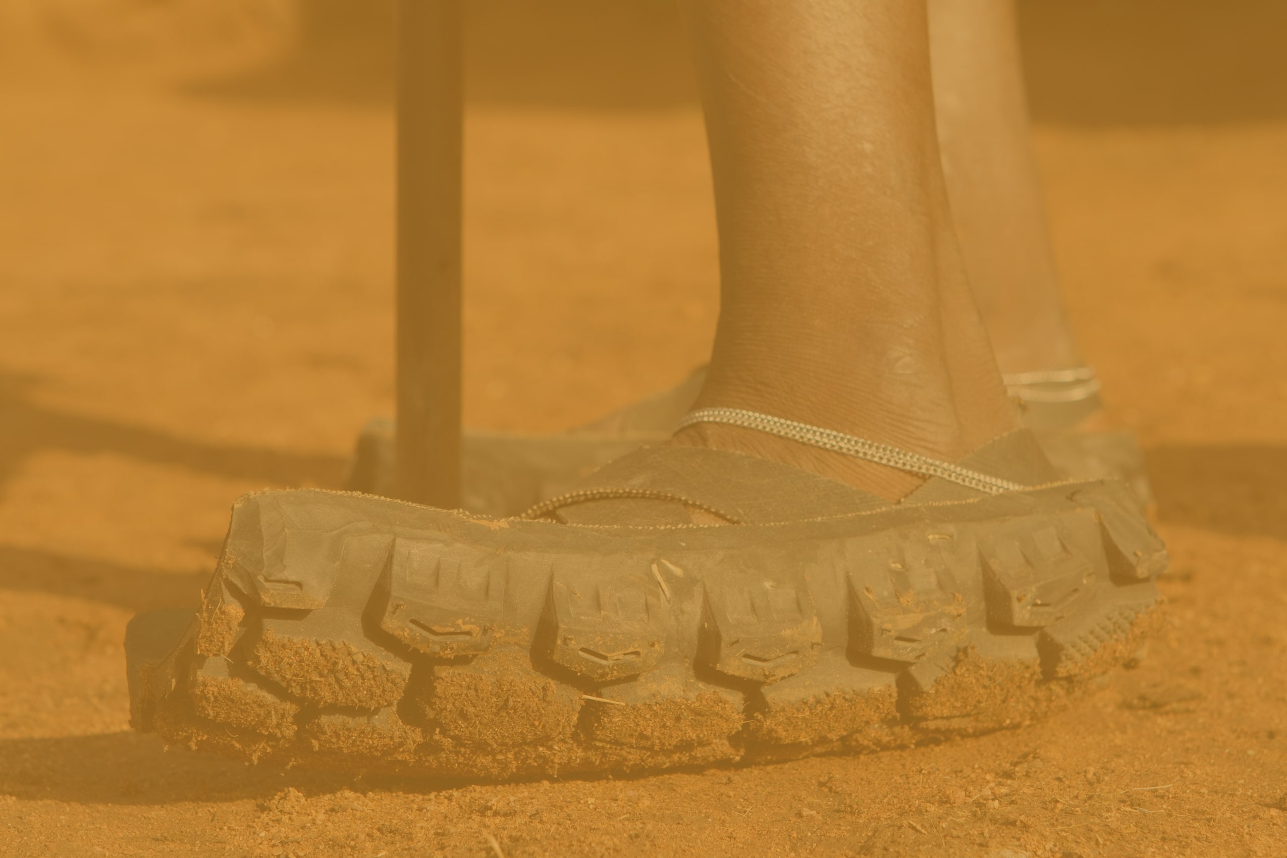 Feet wearing shoes made of tires