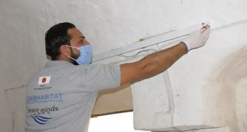 A trainee installing a lighting unit