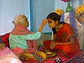 Image 5Senior offering Dashain Tika to junior (from Culture of Nepal)