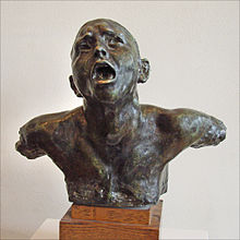 Statue en bronze d'un homme dont on ne voit que la tête et le buste sans bras, bouche ouverte