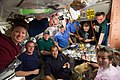 STS-131 and Expedition 23 crew members share a meal